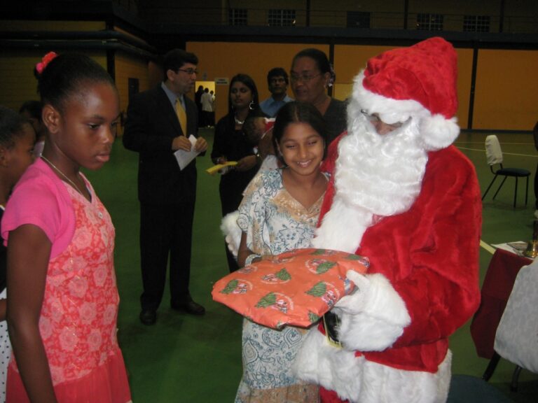 GFLF members look on as Santa puts smiles on the children's faces