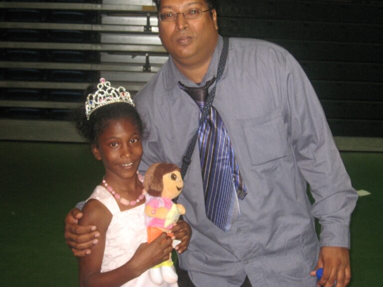 GFLF hardworking member shares a photo with a little princess from Jesus cares family Cottage